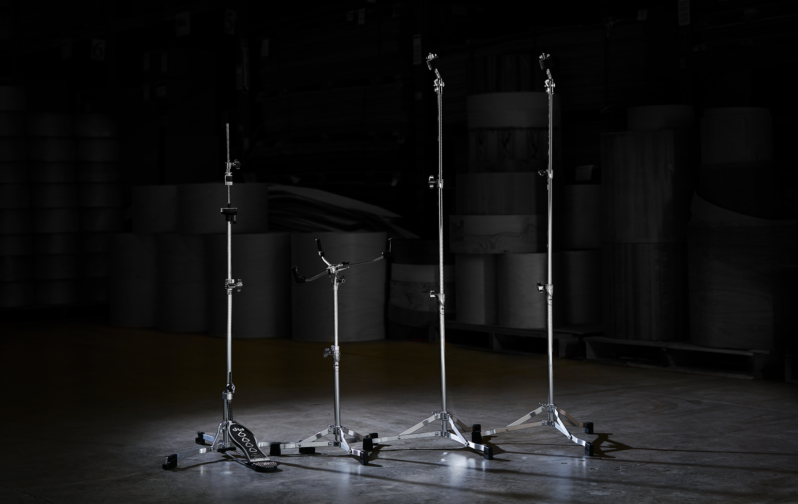 The low-profile, flat-base DW 6000 Series hardware line including a hi-hat stand, stare stand, and two straight-stand.