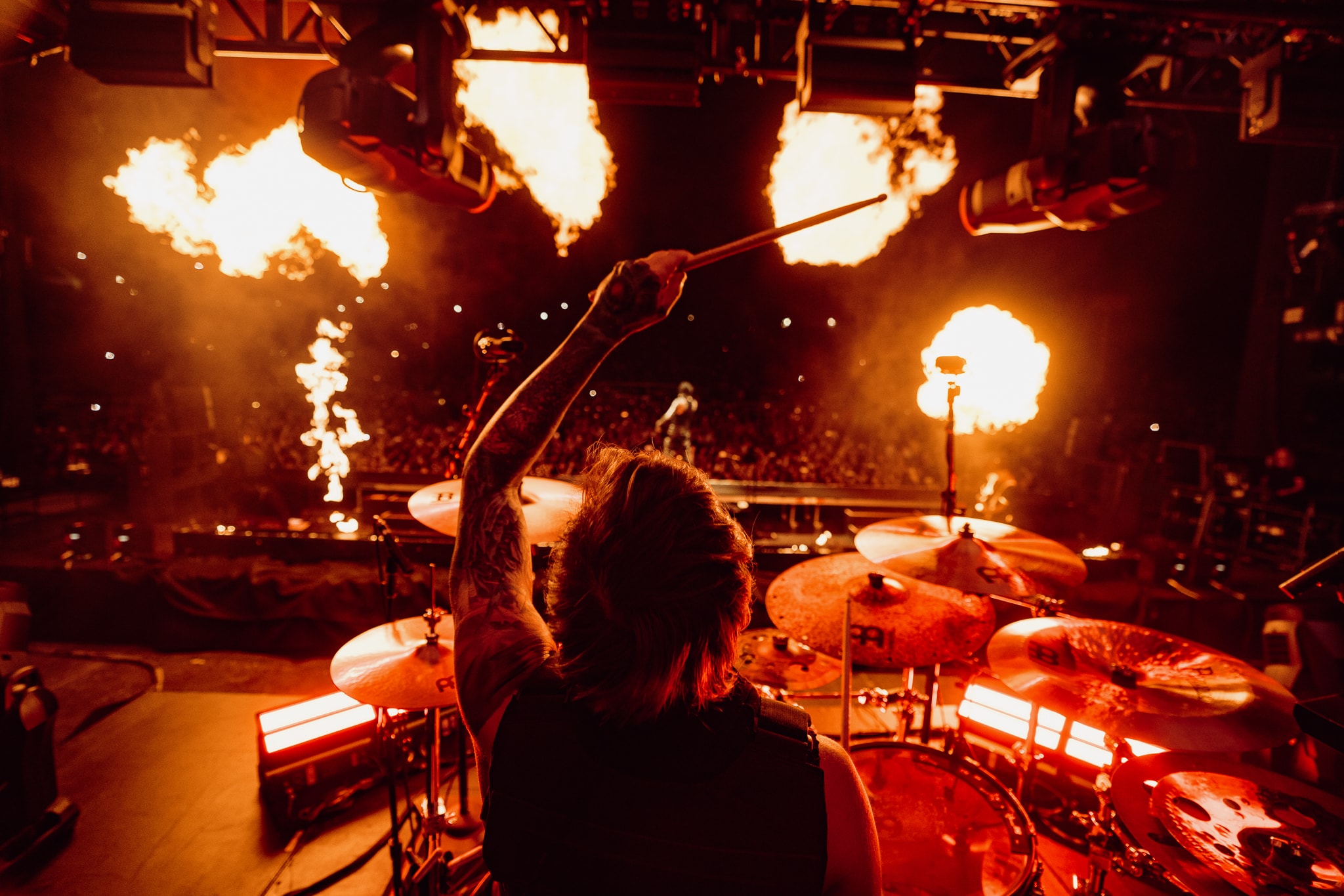 DW Artist Luke Holland plays drums on stage with pyrotechnics